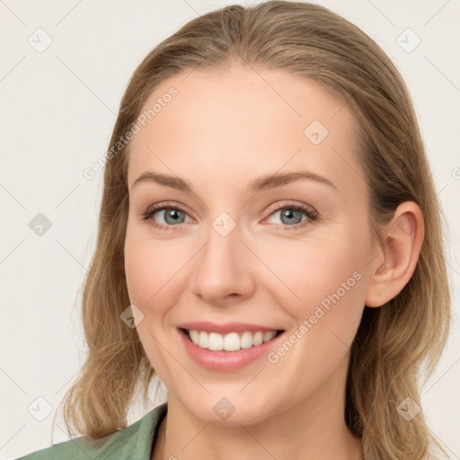 Joyful white young-adult female with long  brown hair and blue eyes