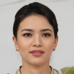 Joyful asian young-adult female with medium  brown hair and brown eyes