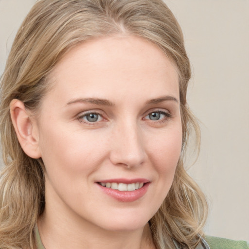 Joyful white young-adult female with medium  brown hair and blue eyes