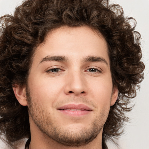 Joyful white young-adult male with medium  brown hair and brown eyes