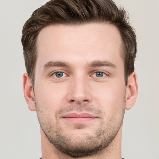 Joyful white young-adult male with short  brown hair and grey eyes