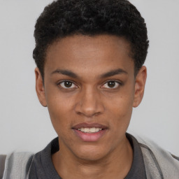 Joyful black young-adult male with short  brown hair and brown eyes