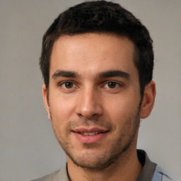 Joyful white young-adult male with short  black hair and brown eyes