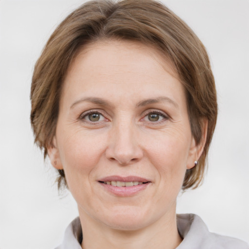 Joyful white adult female with medium  brown hair and grey eyes