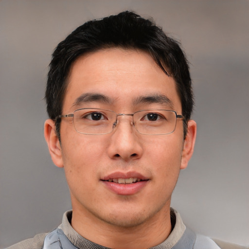 Joyful asian adult male with short  brown hair and brown eyes