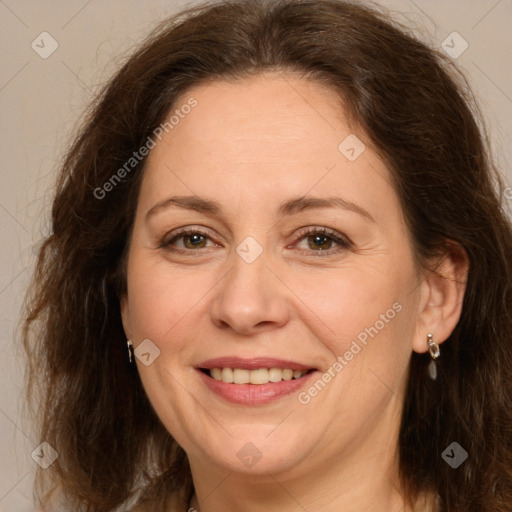 Joyful white adult female with long  brown hair and brown eyes