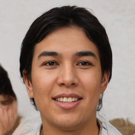 Joyful asian young-adult male with medium  brown hair and brown eyes