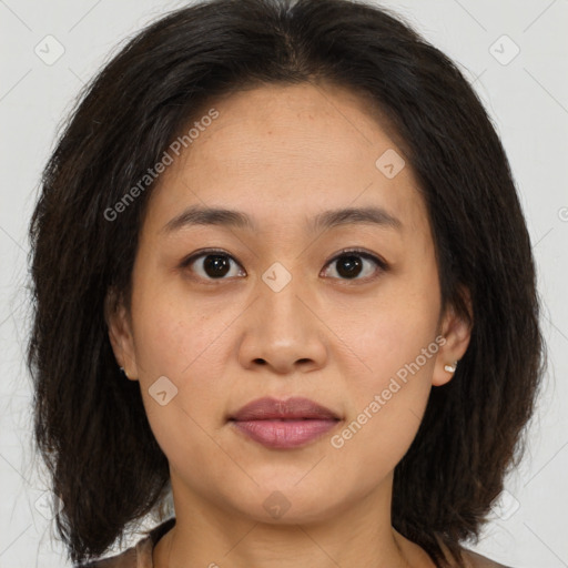 Joyful asian young-adult female with medium  brown hair and brown eyes