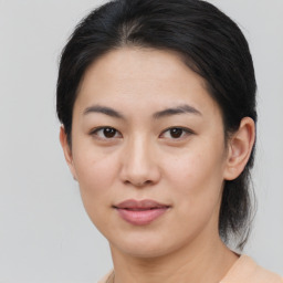 Joyful asian young-adult female with medium  brown hair and brown eyes