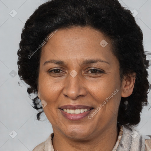 Joyful latino adult female with medium  brown hair and brown eyes