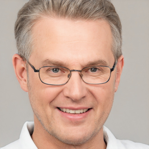 Joyful white adult male with short  brown hair and grey eyes