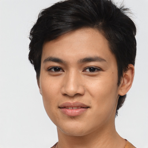 Joyful asian young-adult male with medium  brown hair and brown eyes