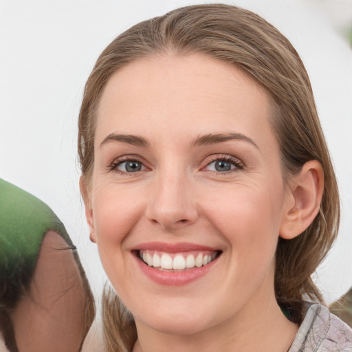 Joyful white young-adult female with medium  brown hair and grey eyes