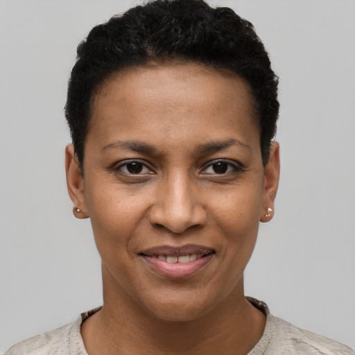 Joyful black young-adult female with short  black hair and brown eyes
