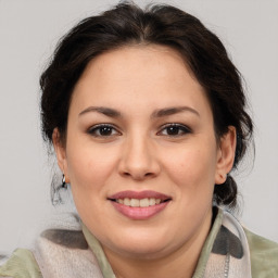 Joyful white adult female with medium  brown hair and brown eyes