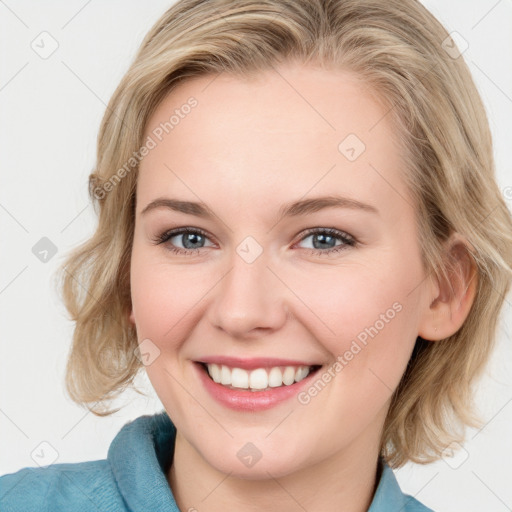 Joyful white young-adult female with medium  brown hair and blue eyes