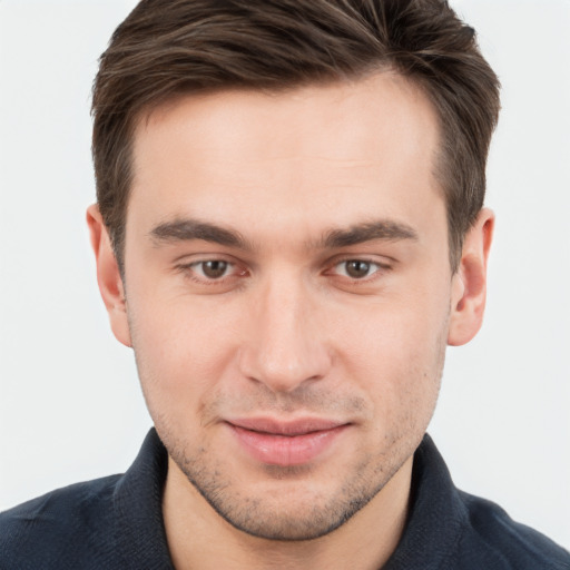 Joyful white young-adult male with short  brown hair and grey eyes