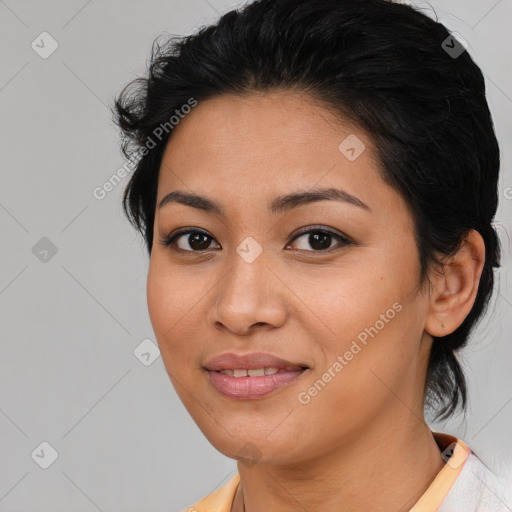 Joyful latino young-adult female with medium  brown hair and brown eyes