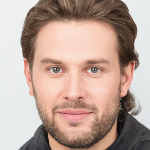 Joyful white adult male with short  brown hair and brown eyes