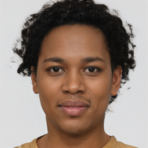 Joyful black young-adult female with short  black hair and brown eyes