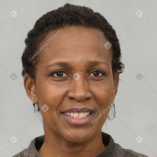 Joyful black adult female with short  brown hair and brown eyes