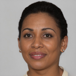 Joyful black young-adult female with short  black hair and brown eyes