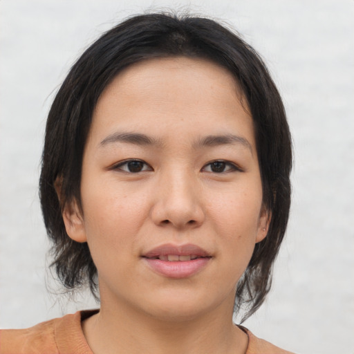 Joyful asian young-adult female with medium  brown hair and brown eyes