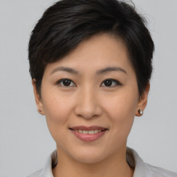 Joyful asian young-adult female with short  brown hair and brown eyes