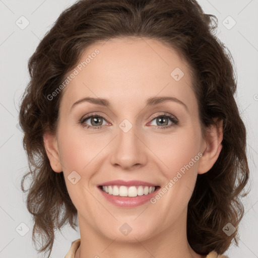 Joyful white young-adult female with medium  brown hair and green eyes