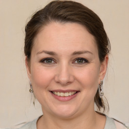 Joyful white young-adult female with medium  brown hair and grey eyes