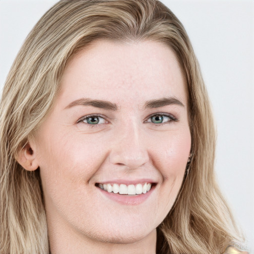 Joyful white young-adult female with long  brown hair and blue eyes