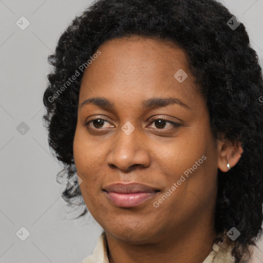 Joyful black young-adult female with long  black hair and brown eyes