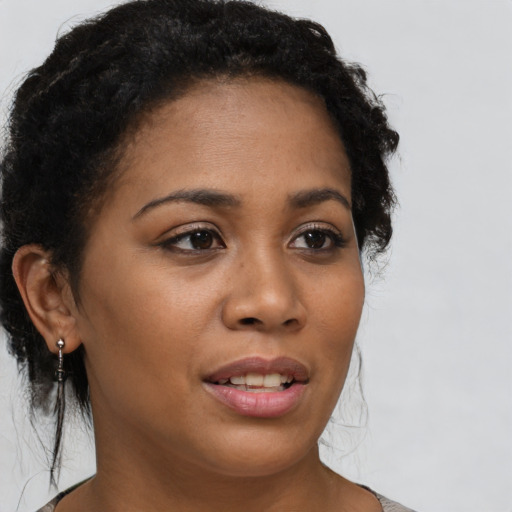 Joyful black young-adult female with medium  brown hair and brown eyes