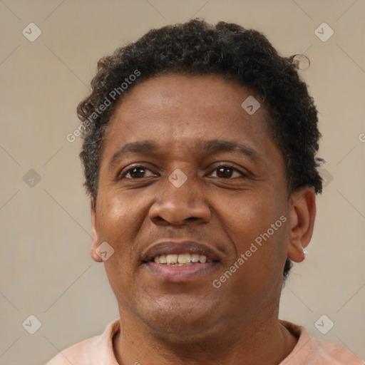 Joyful black adult male with short  brown hair and brown eyes