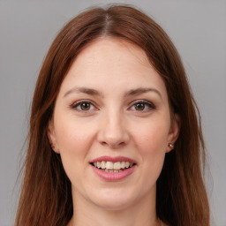 Joyful white young-adult female with long  brown hair and brown eyes