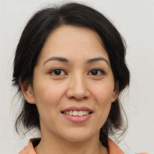 Joyful asian young-adult female with medium  brown hair and brown eyes