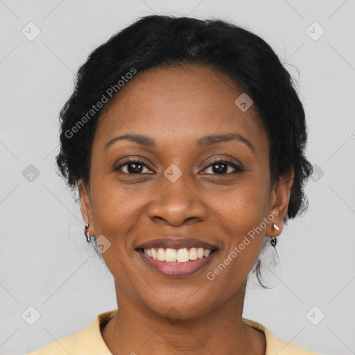 Joyful black adult female with short  brown hair and brown eyes