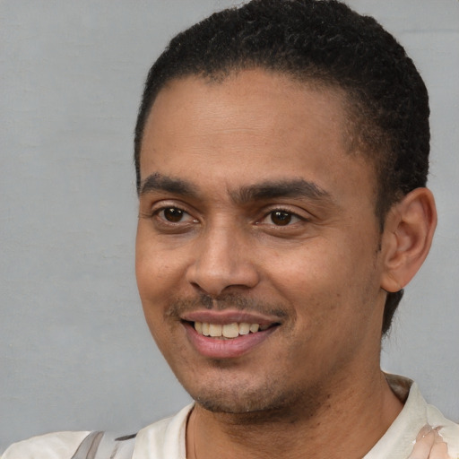Joyful latino young-adult male with short  black hair and brown eyes
