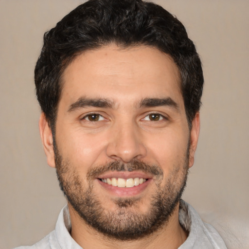 Joyful white young-adult male with short  black hair and brown eyes