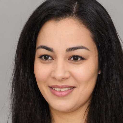Joyful asian young-adult female with long  brown hair and brown eyes