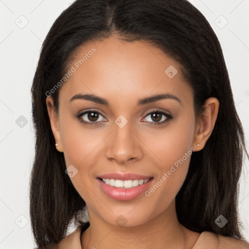 Joyful latino young-adult female with long  brown hair and brown eyes