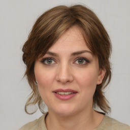 Joyful white young-adult female with medium  brown hair and green eyes