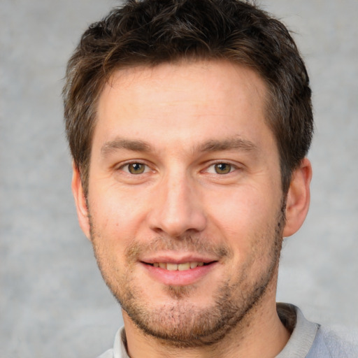 Joyful white adult male with short  brown hair and brown eyes