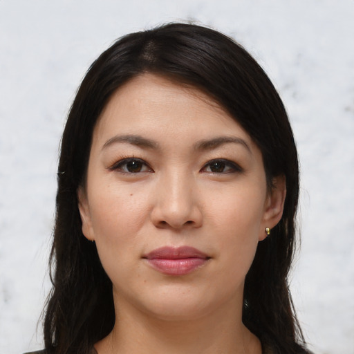 Joyful white young-adult female with long  black hair and brown eyes