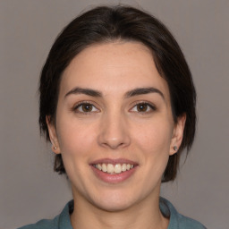 Joyful white young-adult female with medium  brown hair and brown eyes