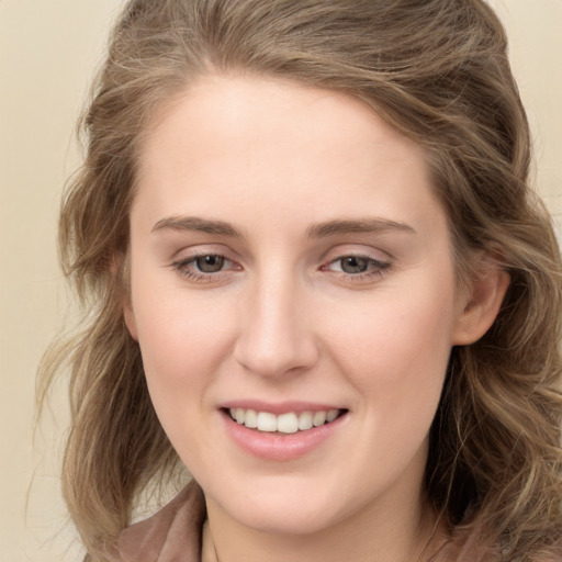 Joyful white young-adult female with long  brown hair and grey eyes