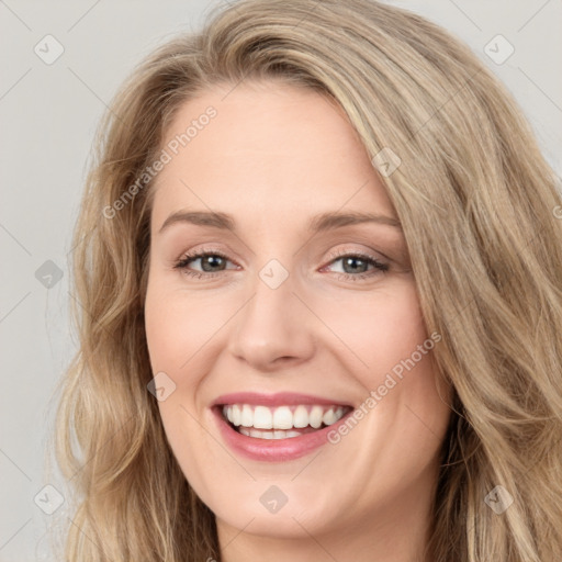 Joyful white young-adult female with long  brown hair and blue eyes