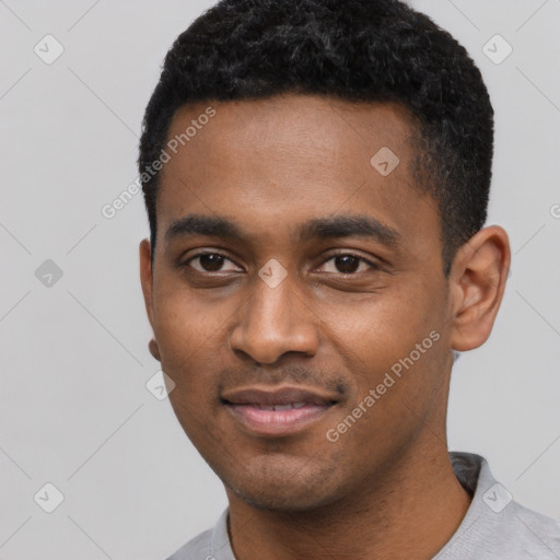 Joyful black young-adult male with short  black hair and brown eyes