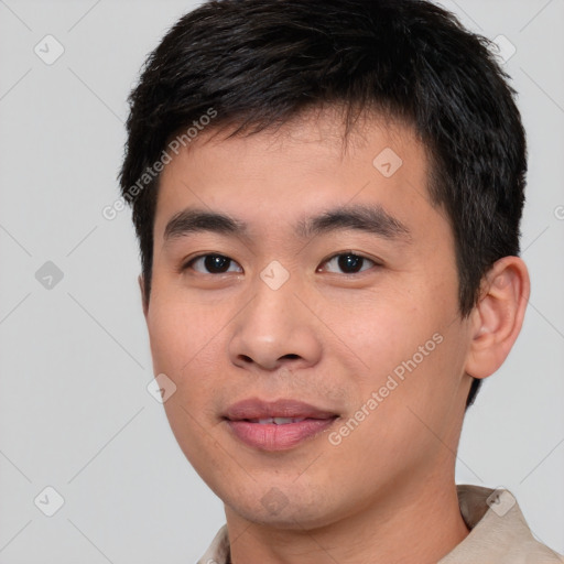 Joyful asian young-adult male with short  brown hair and brown eyes