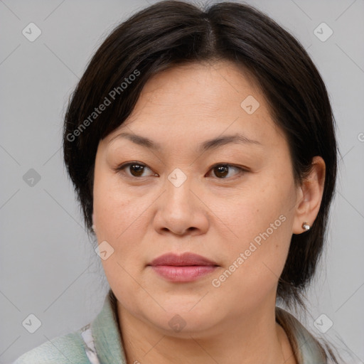 Joyful asian adult female with medium  brown hair and brown eyes